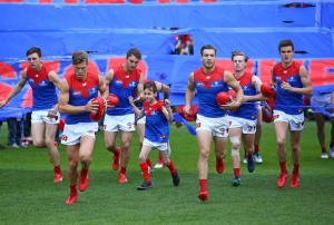 Viney breaks through the banner for his first AFL game in 10 months!