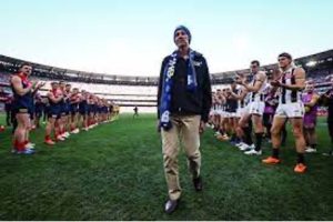 Neale Daniher walking through a guard of honour formed by players of Melbourne and Collingwood at the MCG for Round 13