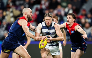 Max Gawn and Jake Lever tackle Mark Blicavs during round 15 AFL Geelong versus Melbourne 2023